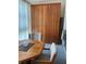 Close-up of the dining area table, chairs, and a large wooden storage cabinet at 6201 2Nd E St # 89, St Pete Beach, FL 33706