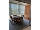 Bright dining area featuring a round table, four chairs, and a built-in storage cabinet at 6201 2Nd E St # 89, St Pete Beach, FL 33706