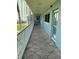 Hallway view with railing, tiled floor, and water view at 6201 2Nd E St # 89, St Pete Beach, FL 33706