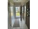 View of a white-tiled hallway leading to the entrance at 6201 2Nd E St # 89, St Pete Beach, FL 33706