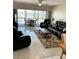 Comfortable living room featuring an open layout to the lanai at 6201 2Nd E St # 89, St Pete Beach, FL 33706