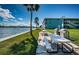Picnic area featuring tables and grills along the waterfront, next to lush lawn at 6201 2Nd E St # 89, St Pete Beach, FL 33706