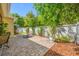 Neutral paver patio with seating overlooks the landscaped backyard and privacy fence at 6405 Sea Lavender Ln, Tampa, FL 33625