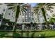 Beautiful condo building featuring mature palm trees and well-maintained landscaping with wrought iron fencing at 700 S Harbour Island Blvd # 404, Tampa, FL 33602