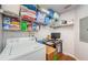 A laundry room featuring a washer, dryer, storage shelves, and a built-in desk at 700 S Harbour Island Blvd # 404, Tampa, FL 33602