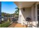 Balcony with a tile floor, metal railing, and a relaxing outdoor chair at 720 Lyndhurst St # 1121, Dunedin, FL 34698