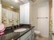 Bathroom featuring granite counters, a large mirror and a shower/tub combo at 720 Lyndhurst St # 1121, Dunedin, FL 34698
