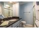 Bathroom with granite vanity and a glass enclosed shower at 720 Lyndhurst St # 1121, Dunedin, FL 34698
