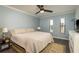 Comfortable bedroom with a king bed, neutral walls, ceiling fan and lots of natural light at 720 Lyndhurst St # 1121, Dunedin, FL 34698