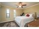 Inviting bedroom boasts hardwood floors, a ceiling fan, and natural light from two windows at 720 Lyndhurst St # 1121, Dunedin, FL 34698