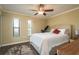 Sunny bedroom boasts a ceiling fan and windows for natural light at 720 Lyndhurst St # 1121, Dunedin, FL 34698