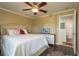 Bedroom featuring neutral walls, a ceiling fan and an ensuite bathroom at 720 Lyndhurst St # 1121, Dunedin, FL 34698