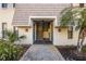 Inviting entryway with tiled walkway leading to stairs, surrounded by lush greenery at 720 Lyndhurst St # 1121, Dunedin, FL 34698
