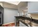 Bright kitchen featuring granite counters, stainless steel sink, and views into the living room at 720 Lyndhurst St # 1121, Dunedin, FL 34698