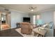 Cozy living room featuring hardwood floors, ceiling fan and access to a balcony at 720 Lyndhurst St # 1121, Dunedin, FL 34698
