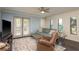 Bright living room with french doors to patio, ceiling fan and comfortable seating at 720 Lyndhurst St # 1121, Dunedin, FL 34698