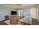 Comfortable living room boasting a ceiling fan, patio access, and light-filled windows at 720 Lyndhurst St # 1121, Dunedin, FL 34698