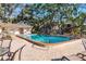 Community pool surrounded by lounge chairs and mature landscaping at 720 Lyndhurst St # 1121, Dunedin, FL 34698