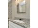 Bathroom featuring a granite countertop vanity and stylish tile shower at 7323 Andre Dr, Zephyrhills, FL 33541