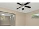 Bright bedroom features neutral walls, light floors, a window, and a ceiling fan at 7323 Andre Dr, Zephyrhills, FL 33541