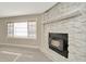 Close up of fireplace with stone surround and modern flooring at 7323 Andre Dr, Zephyrhills, FL 33541