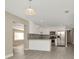 Open-concept kitchen with white cabinets, stainless steel appliances, and new flooring at 7323 Andre Dr, Zephyrhills, FL 33541