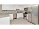 Modern kitchen featuring stainless steel appliances and granite countertops at 7323 Andre Dr, Zephyrhills, FL 33541