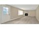 Inviting living room with a cozy stone fireplace and modern flooring at 7323 Andre Dr, Zephyrhills, FL 33541