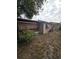 View of the back of the home showing the exterior, foliage and backyard at 7735 Gaston Dr, Port Richey, FL 34668
