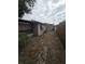 View of the back of the home showing the exterior, foliage and backyard at 7735 Gaston Dr, Port Richey, FL 34668