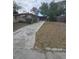 Showing the backyard of the home and the home's exterior, featuring a concrete walkway at 7735 Gaston Dr, Port Richey, FL 34668
