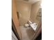 Cozy half bathroom featuring a toilet, vanity, and tiled floor at 7735 Gaston Dr, Port Richey, FL 34668