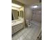 Bathroom featuring neutral-toned walls and flooring, vanity, toilet, and shower/tub at 7735 Gaston Dr, Port Richey, FL 34668