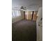 Bedroom with carpet flooring, a window and spacious closets at 7735 Gaston Dr, Port Richey, FL 34668