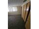 Bedroom with carpet flooring, a window, and spacious closet storage at 7735 Gaston Dr, Port Richey, FL 34668