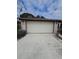 Two car garage and driveway of the home at 7735 Gaston Dr, Port Richey, FL 34668