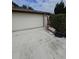 Two car garage and driveway of the home at 7735 Gaston Dr, Port Richey, FL 34668