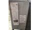 Close-up of the HVAC unit's serial number and safety warning label at 7735 Gaston Dr, Port Richey, FL 34668