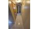 Hallway featuring neutral walls and flooring leading to other rooms in the home at 7735 Gaston Dr, Port Richey, FL 34668