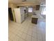 Spacious kitchen with white appliances, tile flooring and a breakfast bar at 7735 Gaston Dr, Port Richey, FL 34668