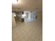 Open concept kitchen with tile flooring and access to the living area at 7735 Gaston Dr, Port Richey, FL 34668