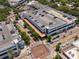 Aerial view showcasing a parking garage in a bustling area with surrounding buildings and greenery at 800 S Dakota Ave # 221, Tampa, FL 33606