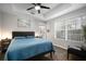 Spacious bedroom featuring a ceiling fan, large window, and an ensuite bathroom at 800 S Dakota Ave # 221, Tampa, FL 33606