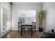 Charming dining area with hardwood floors, a bright window, a table for two and an exterior door at 800 S Dakota Ave # 221, Tampa, FL 33606