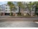 Apartment building with garages and brick entrance, sidewalk and manicured plants at 800 S Dakota Ave # 221, Tampa, FL 33606