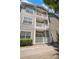 Three-story building featuring private balconies with white railings and lush landscaping at 800 S Dakota Ave # 221, Tampa, FL 33606