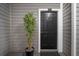 Apartment front door with unit number, doormat and potted plant decoration at 800 S Dakota Ave # 221, Tampa, FL 33606