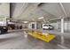 Indoor parking garage with yellow parking and no-parking zones, car wash area, and vehicle parking at 800 S Dakota Ave # 221, Tampa, FL 33606
