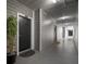 Hallway with apartment door featuring a decorative plant, doormat and unit number at 800 S Dakota Ave # 221, Tampa, FL 33606