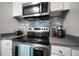 Stylish kitchen featuring stainless steel appliances, sleek countertops and modern microwave at 800 S Dakota Ave # 221, Tampa, FL 33606